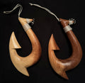 two different wooden fish hook